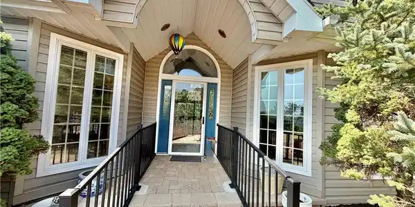 Image 2: An inviting entry with an arched portico welcomes