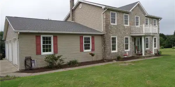 Image 4: Textured stone veneer accents the exterior facade