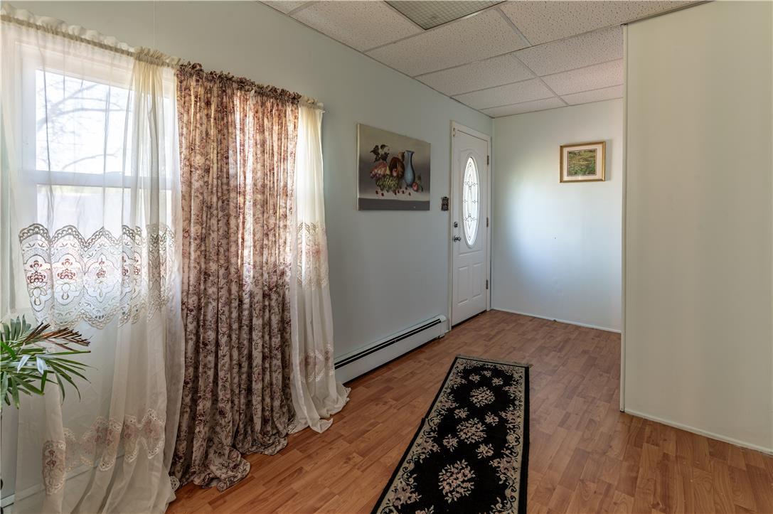 Image 3: A welcoming entryway with warm wood flooring and a
