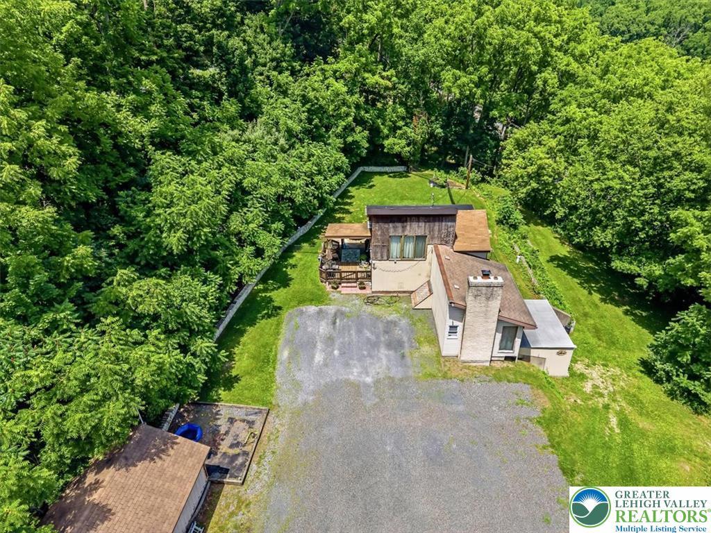 Image 4: Perched on a verdant hillside, this residence offe