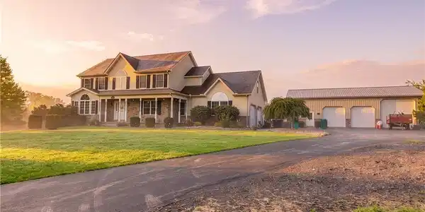 Image 2: A spacious driveway leads to this multi-level home