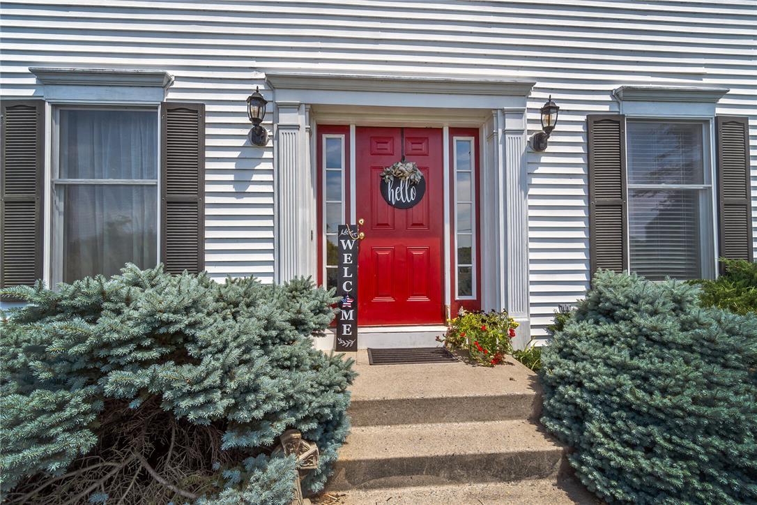 Image 2: A vibrant red entry door creates a striking focal
