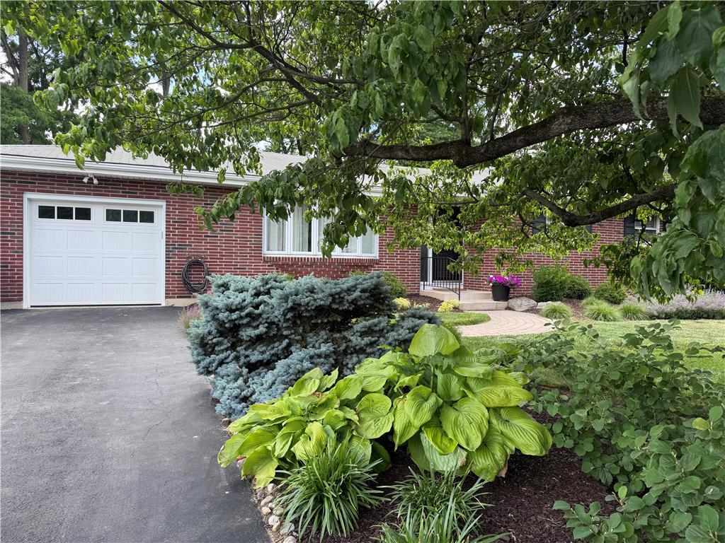 Image 3: Mature trees and vibrant landscaping frame this in