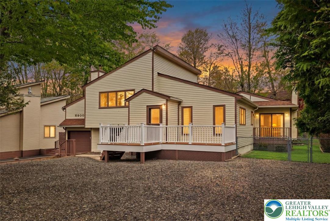 Image 1: This residence features a deck for outdoor enjoyme