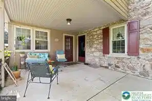 Image 4: Natural stone masonry and a sheltered concrete pat