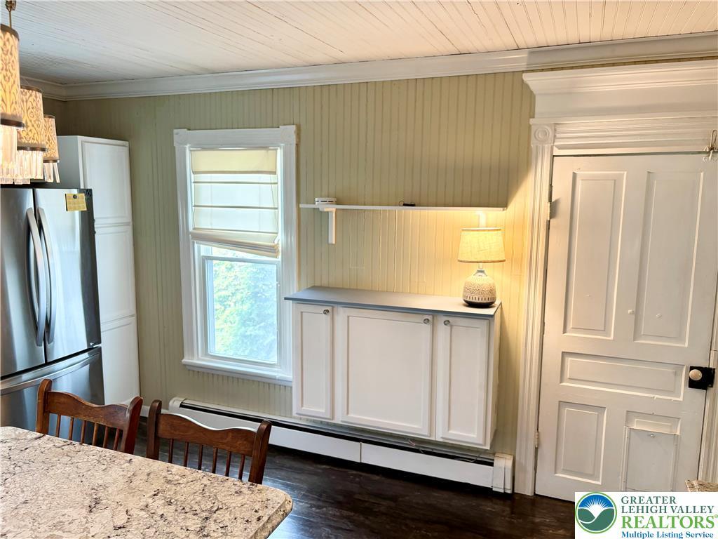 Image 4: A well-lit kitchen with classic paneling, rich flo
