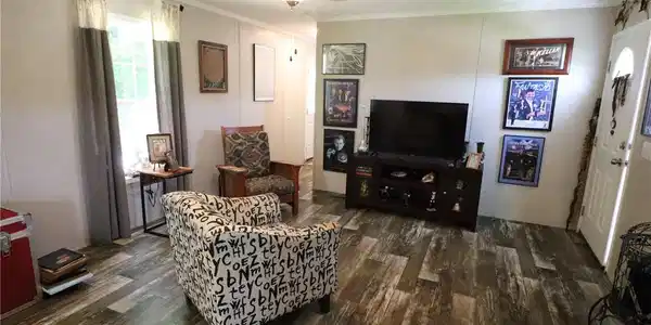 Image 3: A well-lit living area showcases durable vinyl flo