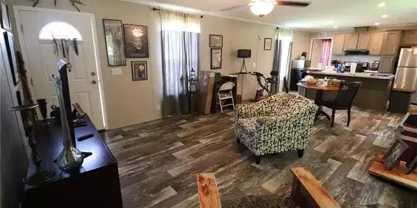 Image 4: An open-concept living space with rustic flooring