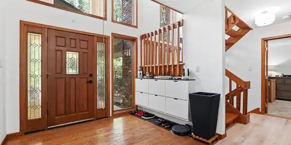 Image 3: Warm wood floors and soaring high ceilings frame a