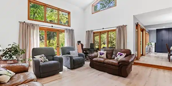 Image 4: Soaring ceilings and warm wood-framed windows defi