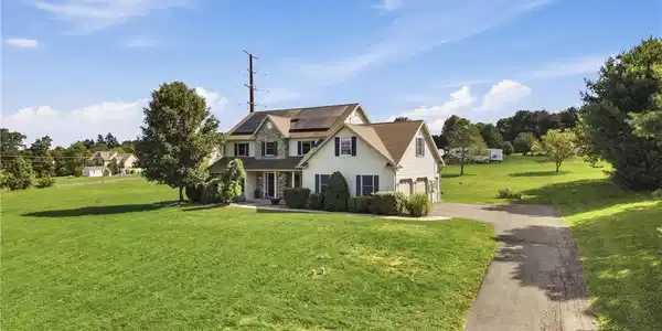 Image 3: An asphalt driveway leads to this multi-level coun