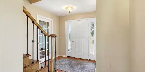 Image 4: A welcoming entryway features polished hardwood fl