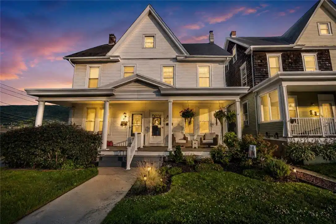 Image 1: A classic facade with a welcoming porch offers eve