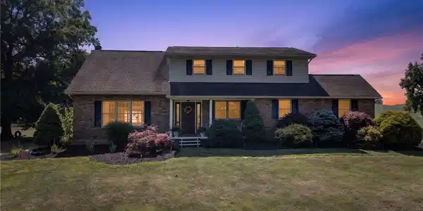 Image 2: A classic brick-front home with a welcoming entry