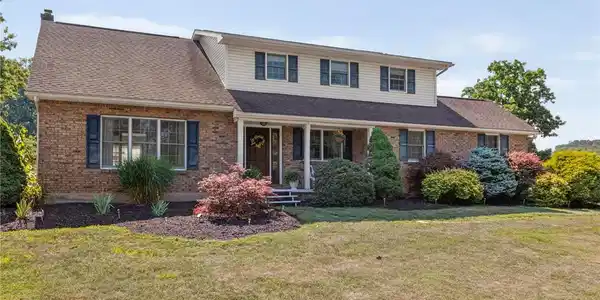 Image 4: A classic brick-front residence presents a welcomi