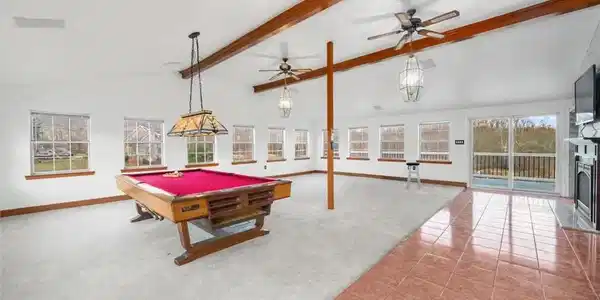 Image 4: A spacious recreation room featuring high ceilings