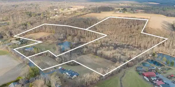 Image 2: An aerial perspective reveals a vast rural propert