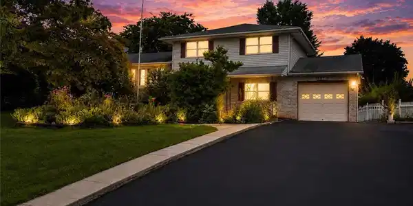 Image 2: Dramatic sunset hues frame this home's inviting ex