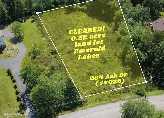 Image 1: A spacious, ready-to-build half-acre lot surrounde
