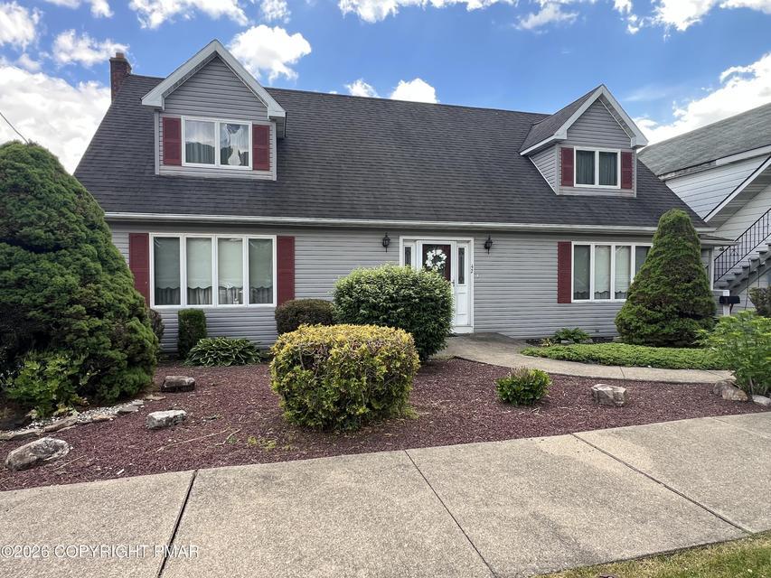 Image 2: A well-maintained facade with neat landscaping and