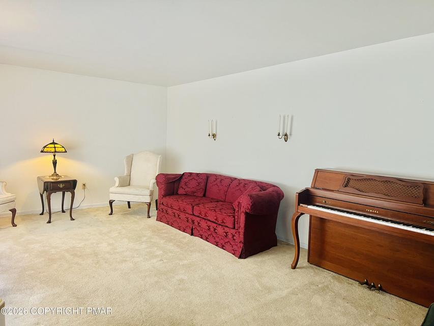Image 4: Well-maintained carpeting provides comfort in this