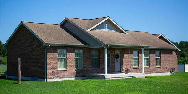 Image 2: A multi-gabled shingle roof define this classic on