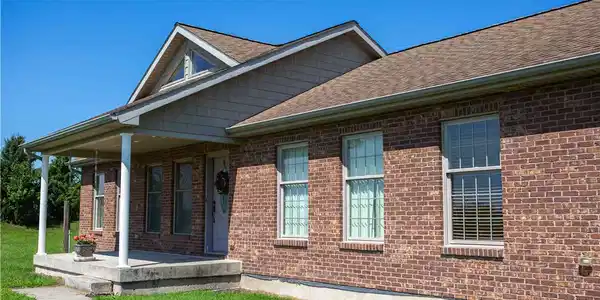 Image 4: A welcoming front porch and shaker shingles highli