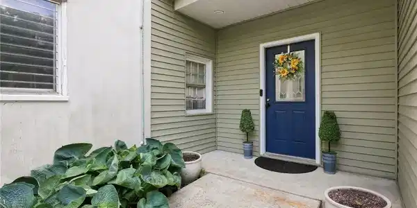 Image 2: An inviting covered entryway welcomes with neat si