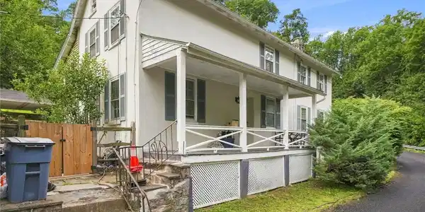 Image 3: A classic covered front porch welcomes visitors to