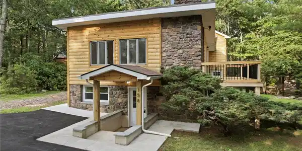 Image 2: A charming blend of log and stone construction cre