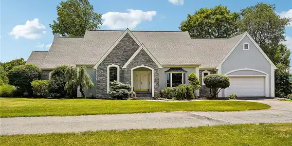 Image 2: A graceful home with a stone and stucco facade, ne