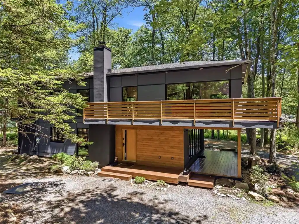 Image 1: A modern architectural marvel nestled among the tr