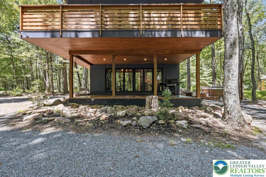 Image 4: Modern retreat nestled amongst trees, featuring a