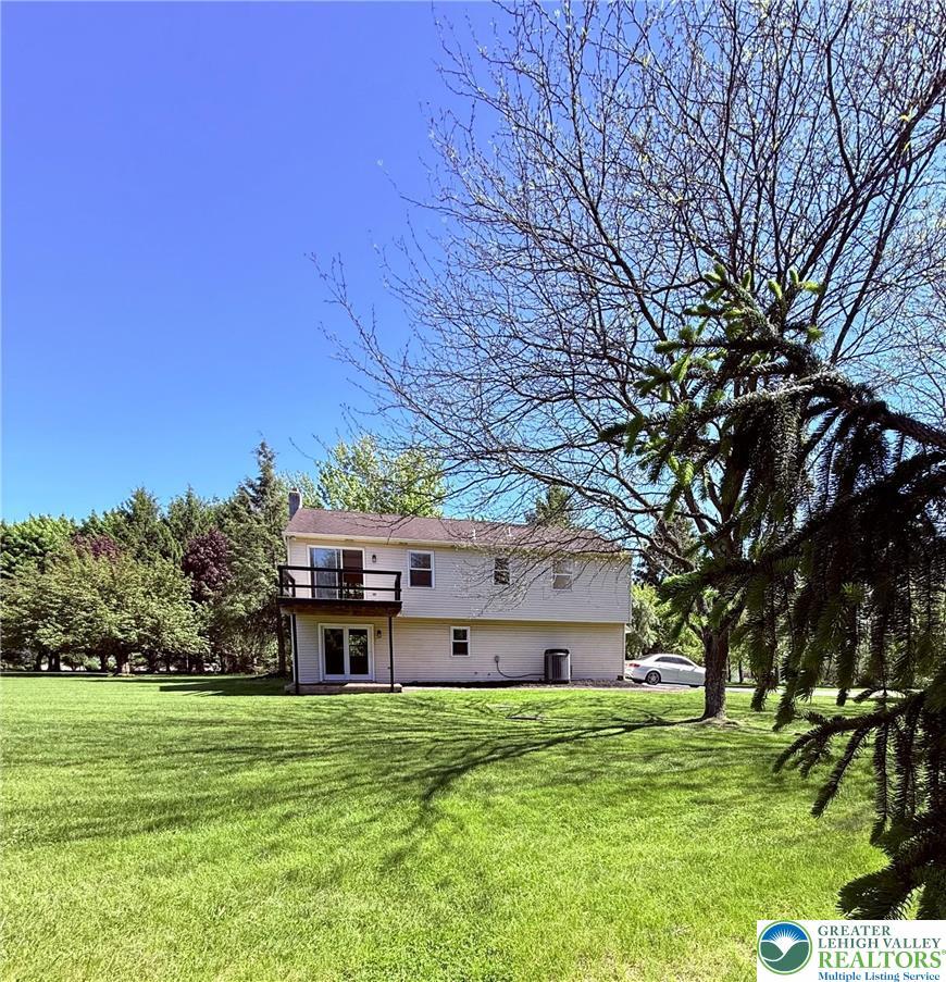 Image 2: This spacious property offers a serene backyard pe