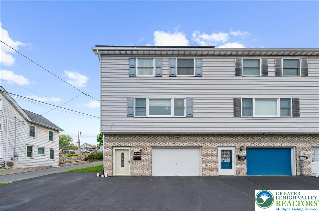 Image 2: This charming duplex features classic siding and b
