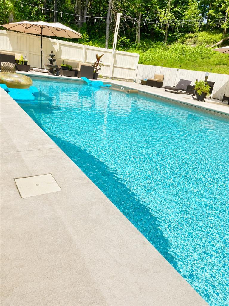 Image 4: This serene outdoor oasis features a sparkling poo
