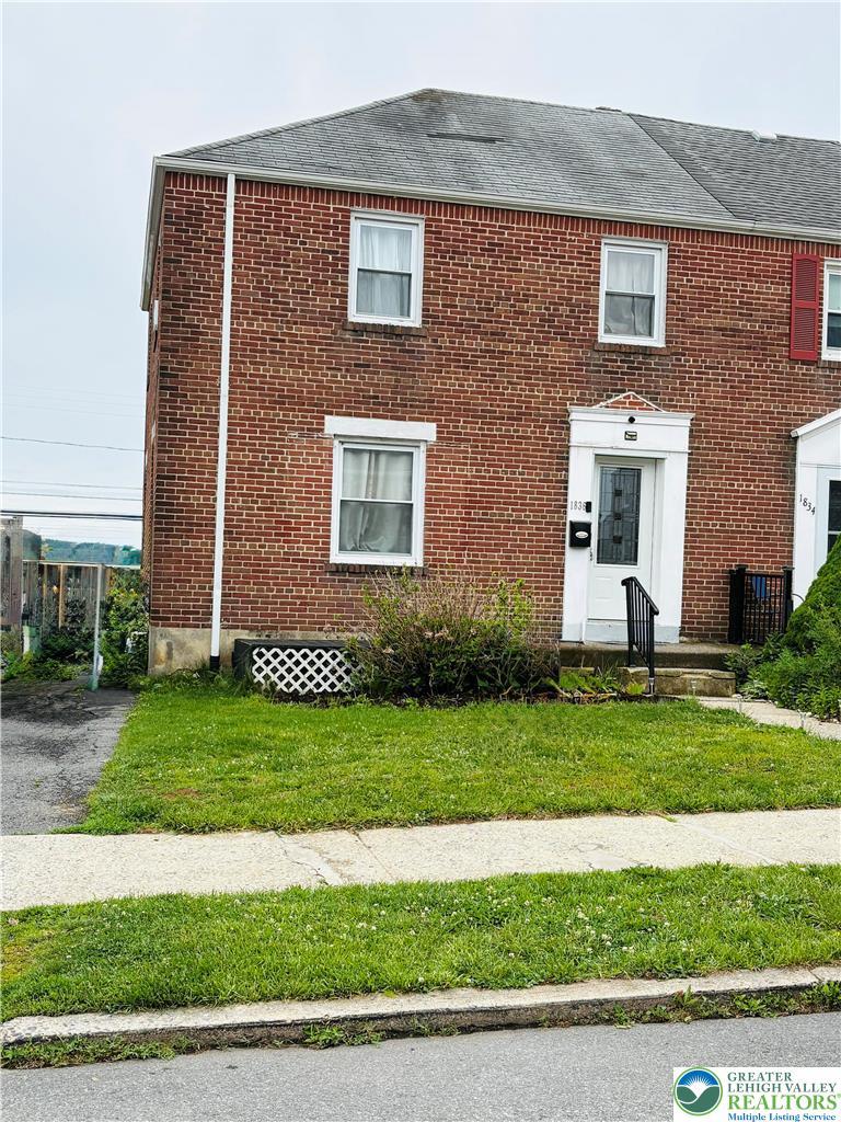 Image 2: A classic brick exterior presents a welcoming fron