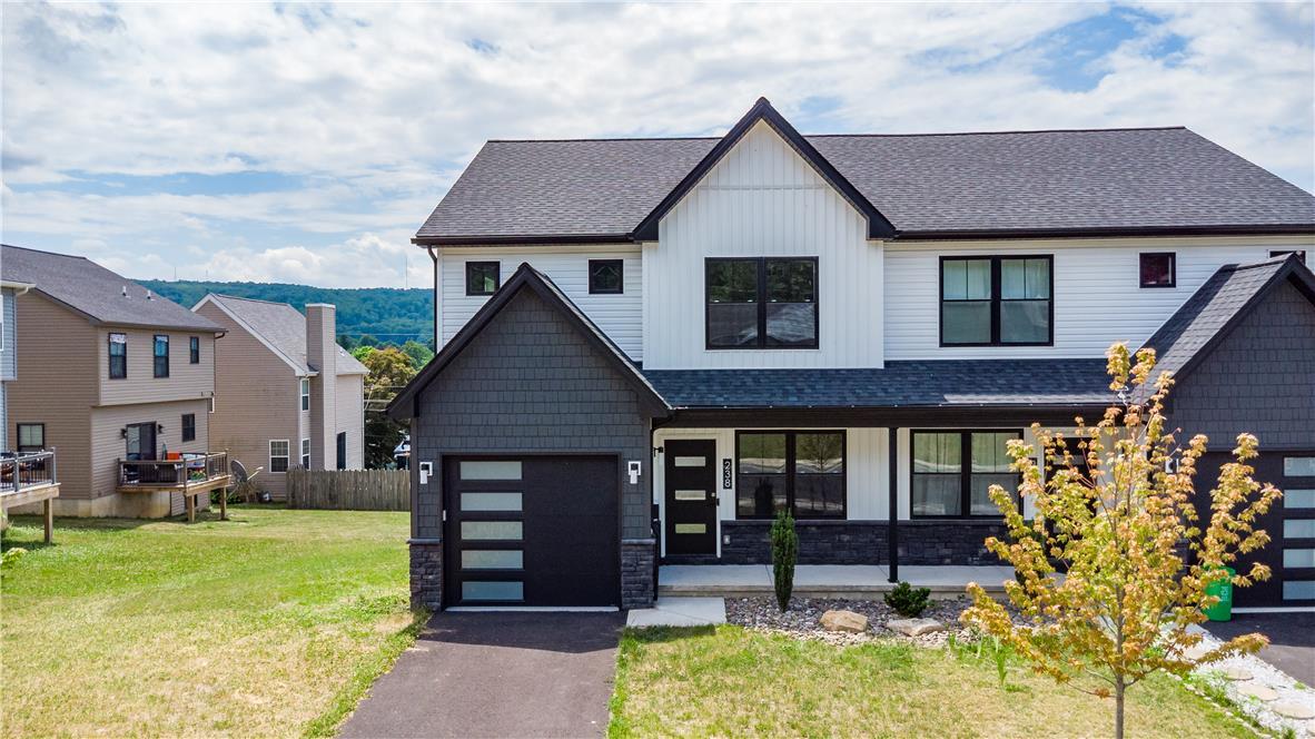 Image 3: A striking modern facade with contrasting siding a