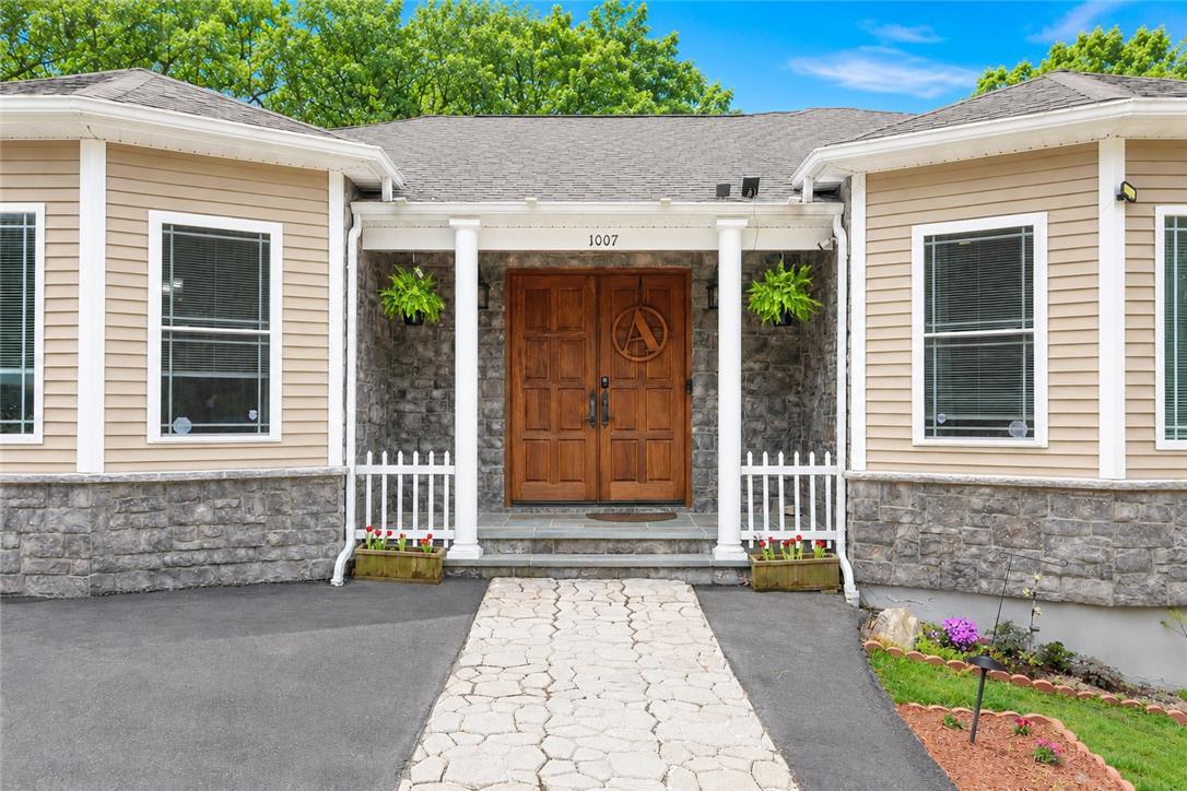 Image 2: A welcoming stone and siding facade offers a grand
