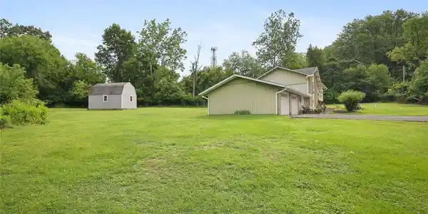 Image 4: Mature trees frame a vast lawn featuring a detache