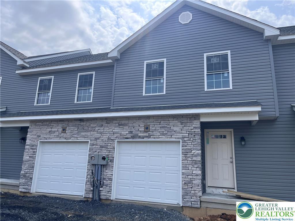 Image 1: Stone veneer, attached garage.