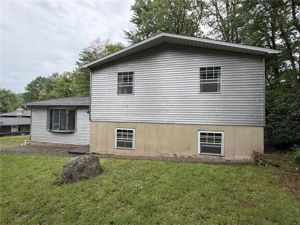 Image 4: A classic facade with sturdy siding and a visible