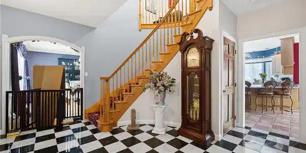 Image 2: A grand wooden staircase with a graceful curve anc