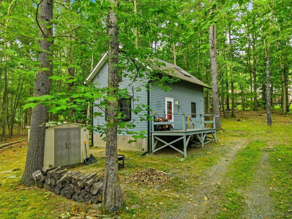 Image 2: A secluded retreat nestled in lush woods with a ch