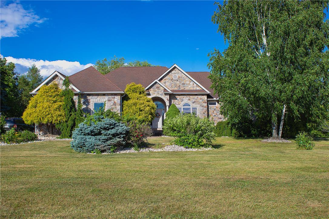 Image 3: A classic stone-faced residence framed by verdant