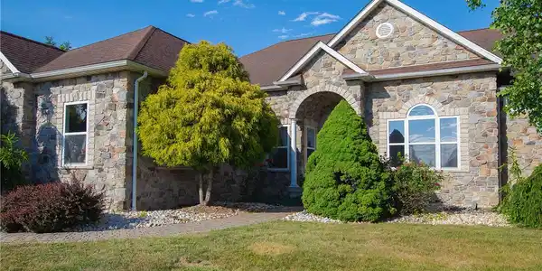 Image 4: A classic stone facade with an arched entryway wel