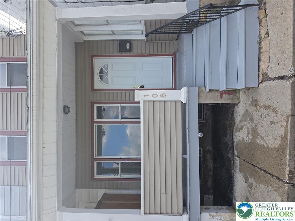 Image 3: A welcoming front entrance, featuring a white door