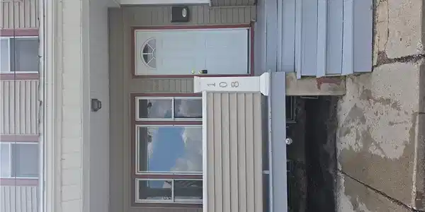 Image 3: A welcoming front entrance, featuring a white door