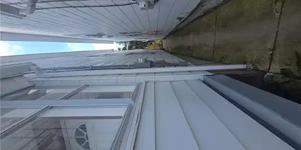 Image 4: View the narrow concrete pathway between two struc