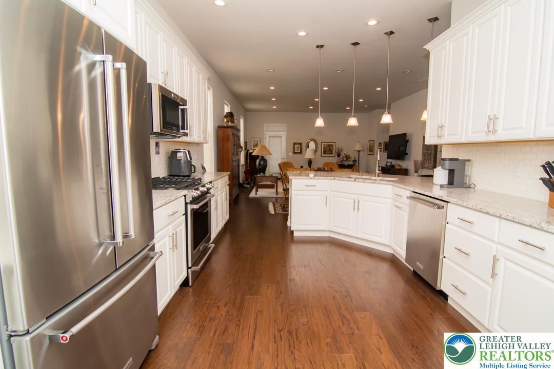 Image 2: Culinary delights await in this bright kitchen wit